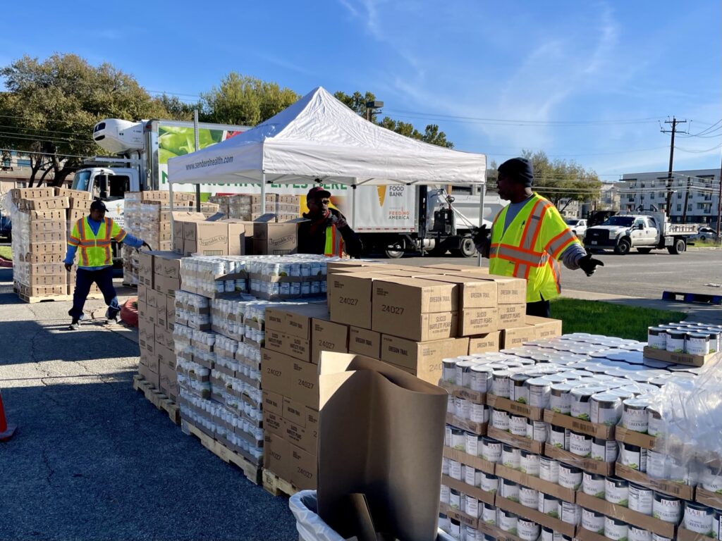 Volunteers from Austin Public Works prepare to distribute 1,000 turkeys and over 16,000 sides donated by Sendero Health Plans and Austin Public Health to elderly, disabled and low-income residents Saturday, November 13 at The East Austin Neighborhood Center.